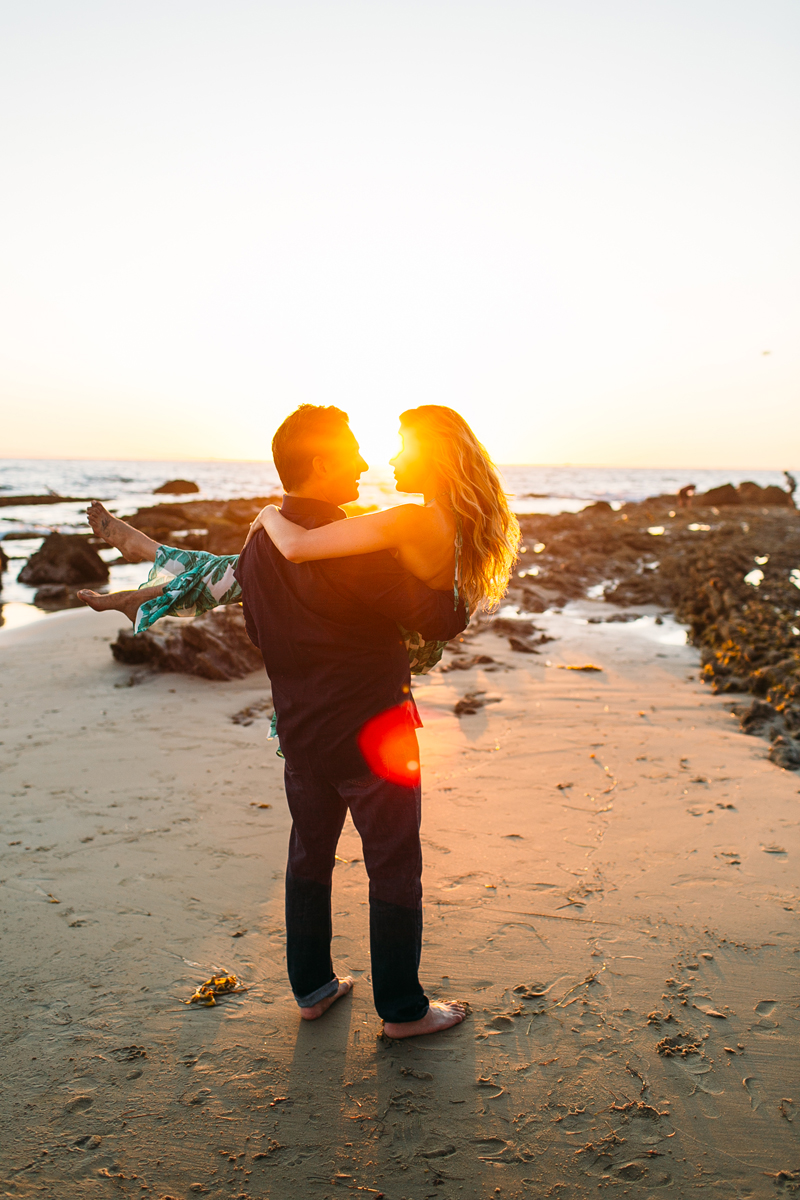 Romantic Couple playing on the beach in Laguna Beach for Engagement Photos