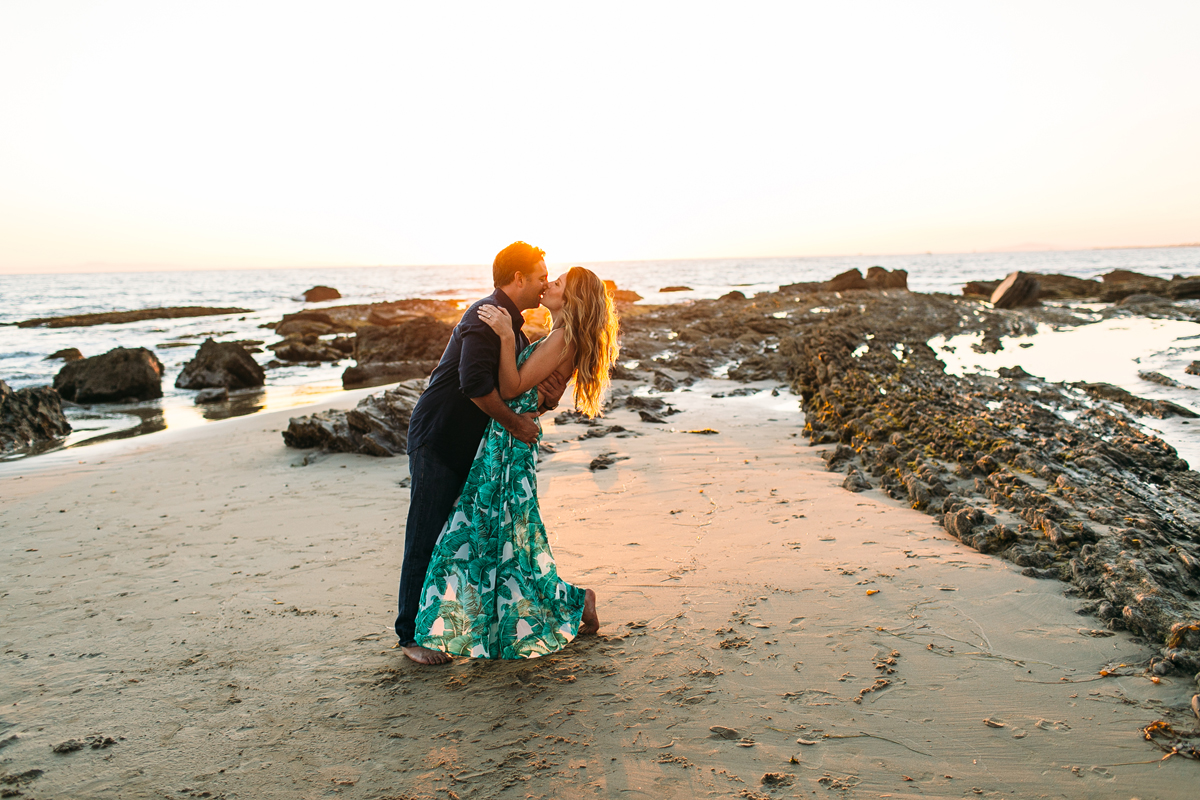 Romantic Couple playing on the beach in Laguna Beach for Engagement Photos