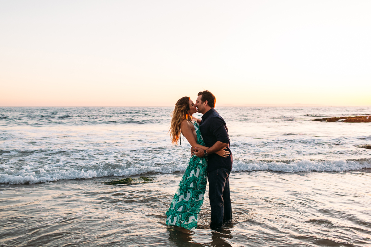Couple playing in the ocean in Laguna Beach for Engagement Photos