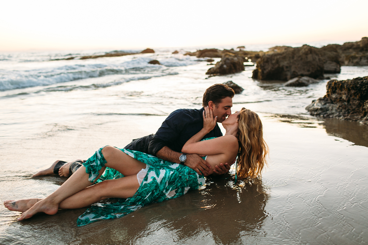 Romantic Couple playing in the ocean in Laguna Beach for Engagement Photos