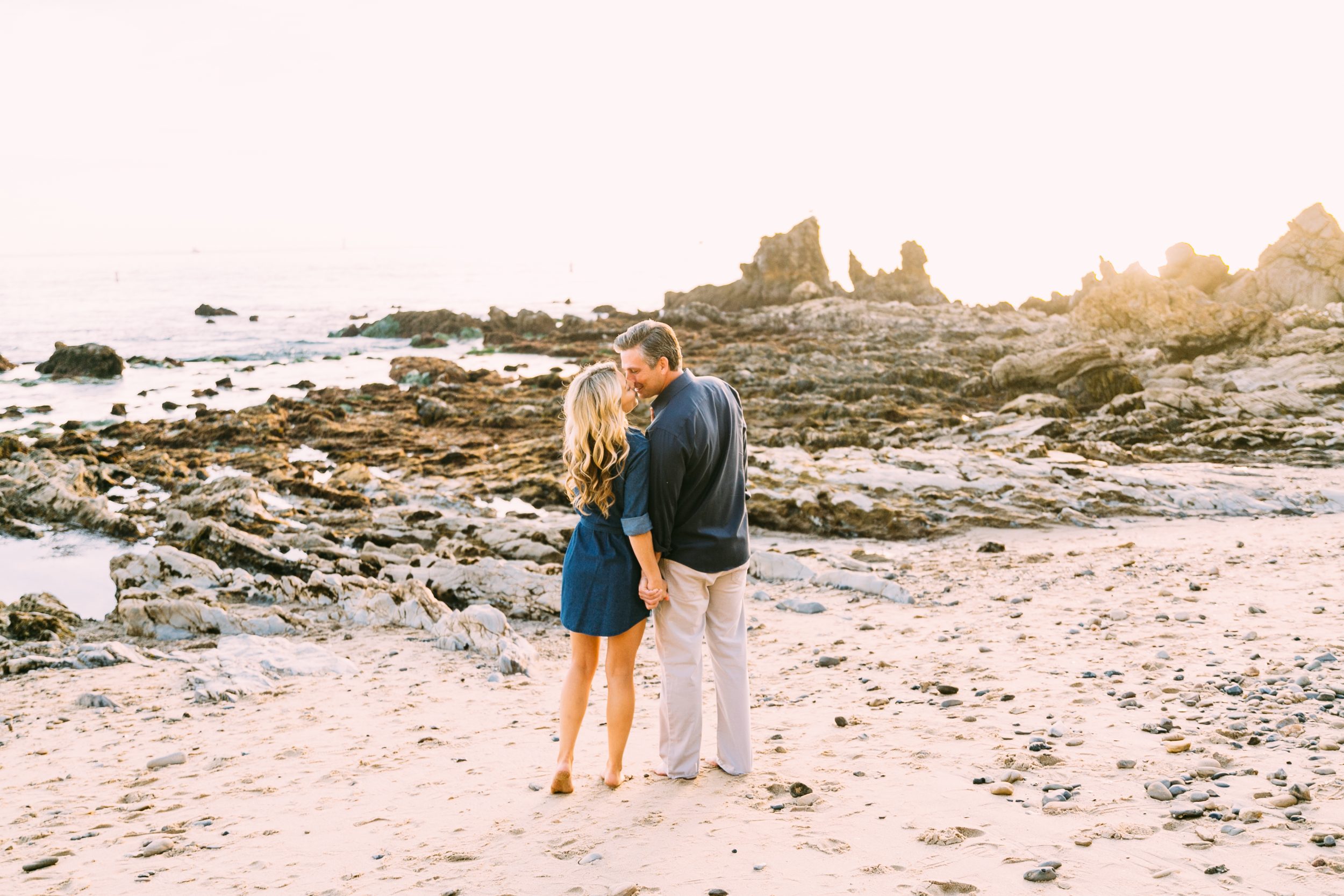 Romantic Beach Engagement Session in Corona Del Mar couple kissing on the beach