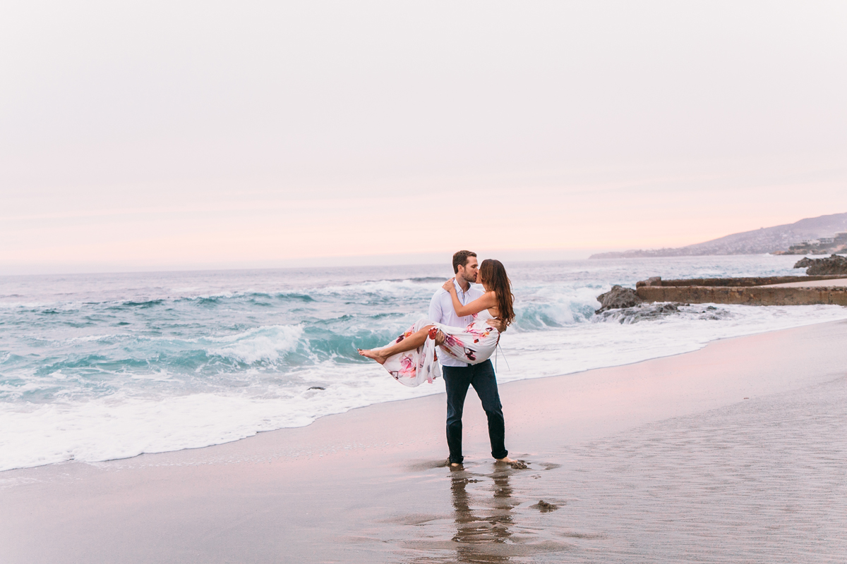 Romantic Engagement Photos on Victoria Beach in Laguna Beach, Fiance lifting bride to be up