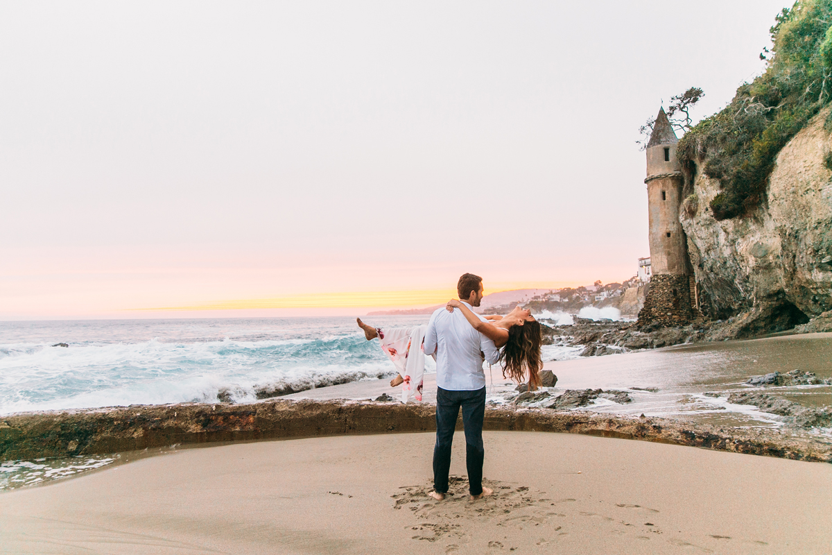 playful couple on the beach in Laguna for Engagement Photos